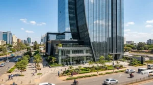 Modern commercial office building exterior in Nairobi, Kenya, glass facade and landscaped entrance
